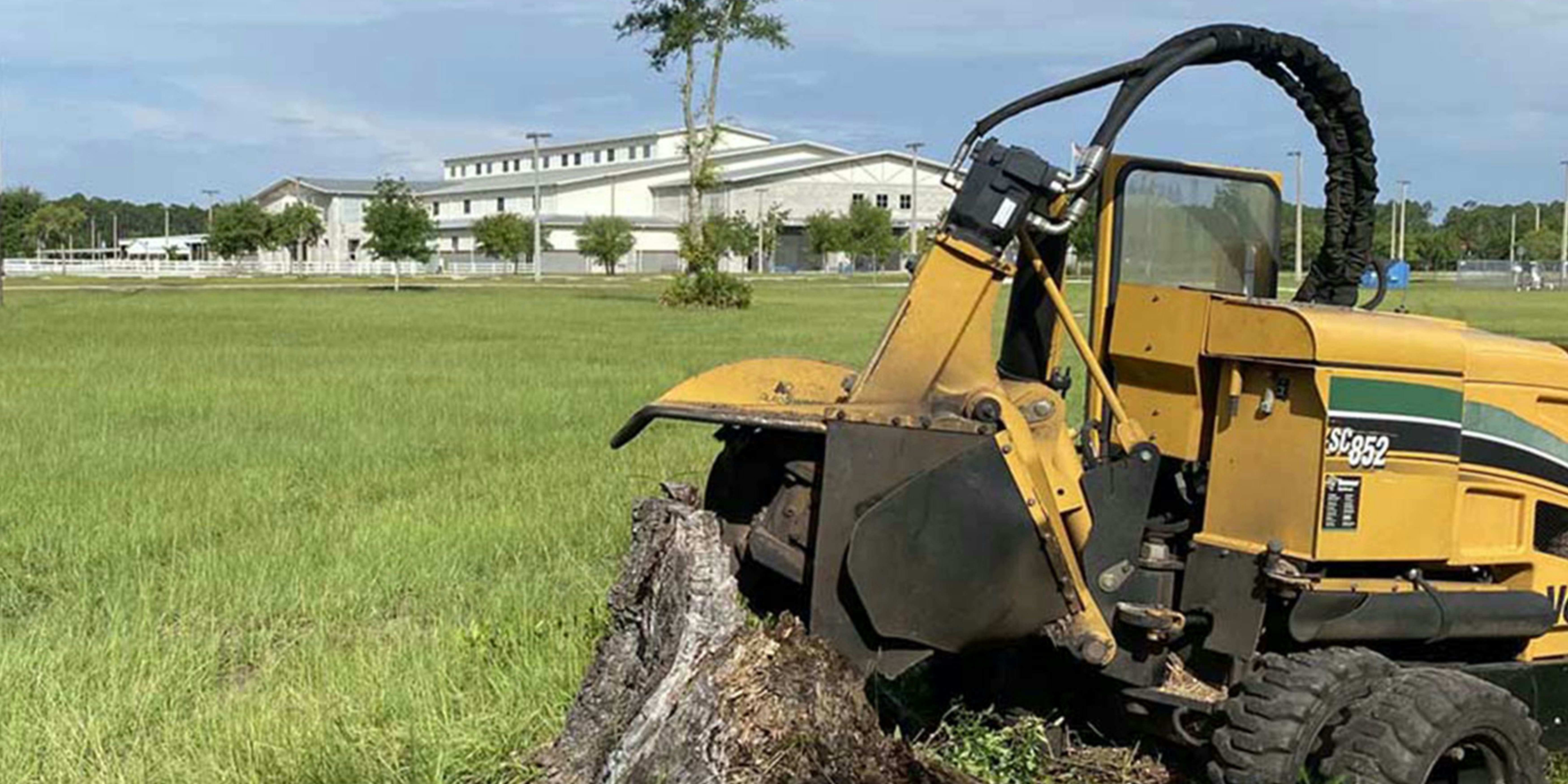 Stump grinding machine in action, removing a tree stump efficiently